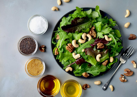 A plate of salad with mixed nuts and vinaigrette dressing.の写真素材