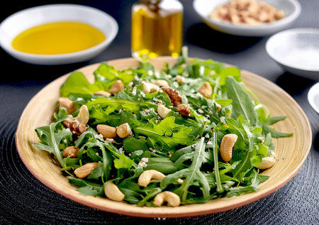 A plate of salad with mixed nuts and vinaigrette dressing.の写真素材
