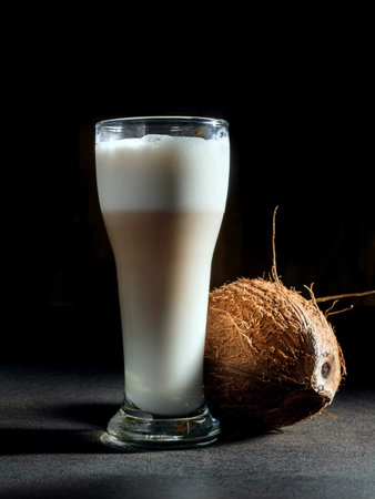 Coconut latte in a tall glass and coconutの写真素材
