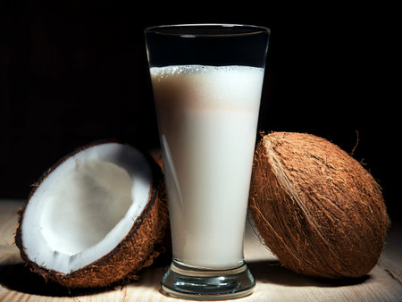 Coconut latte in a tall glass and coconut.の写真素材