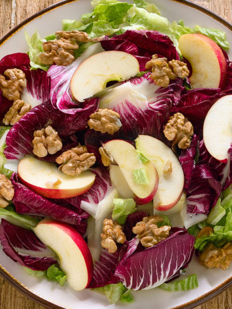 Radicchio salad with apples and walnuts. Full of nutritious ingredients and lots of vitamins.の写真素材