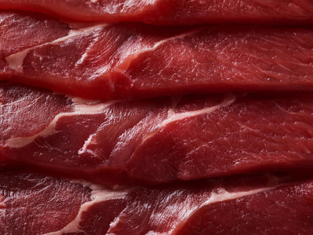 Close-up of fresh, uncooked beef slices arranged in layers, showing the rich red color and marbled texture. Perfect for barbecue, grilling, or gourmet recipes. Perfect for promotionの写真素材