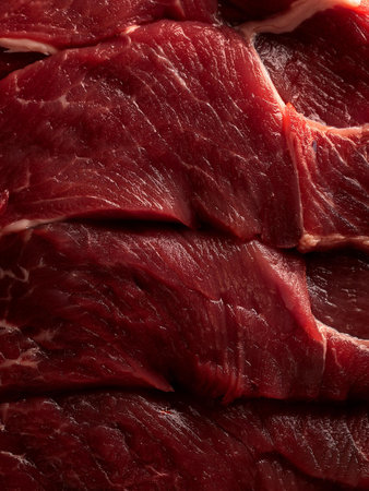 Close-up of fresh, uncooked beef slices arranged in layers, showing the rich red color and marbled texture. Perfect for barbecue, grilling, or gourmet recipes. Perfect for promotionの写真素材