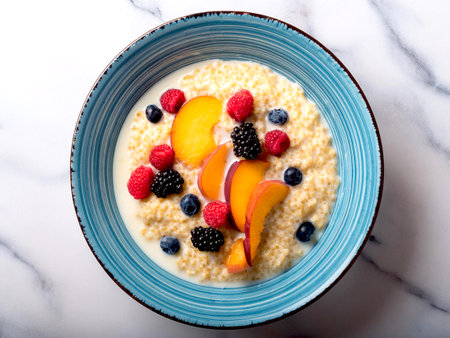 Buckwheat cooked with milk served in a ceramic bowl with fruit. A healthy breakfast.の写真素材