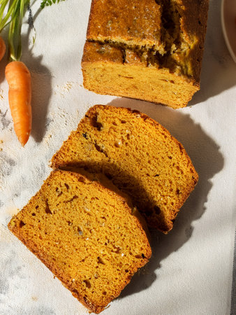 Tempting carrot cake cut into slices, highlighting its vibrant color and moist texture.の写真素材