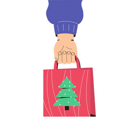 Hand holds a Christmas gift package. The concept of preparing for the winter holidays. Christmas shopping. Advertising web banner for Christmas.のイラスト素材