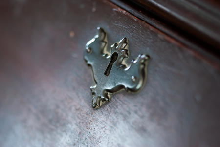 A closeup of an lock on an antique cabinet.の写真素材