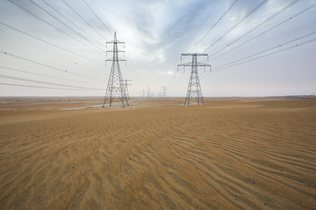 powerlines in a desert near Abu Dhabiの写真素材