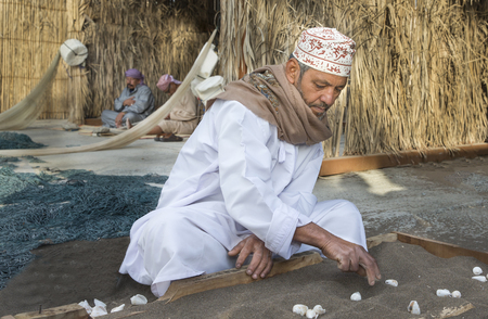 Muscat, Oman, February 4th, 2017: omani men playing hawalais game with shellsのeditorial素材