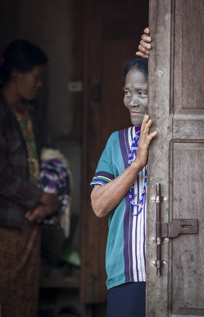 Chin region, Myanmar, November 11, 2014: daai tribe woman at her front doorのeditorial素材