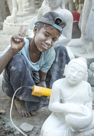 Mandalay, Myanmar, November 15th, 2014: marble worker working outside his workshopのeditorial素材