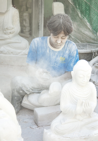 Mandalay, Myanmar, November 15th, 2014: marble worker working outside his workshopのeditorial素材