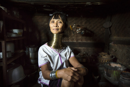 Lake Inle, Myanmar, November 17th 2014: Paduang Tribal woman i her kitchenの写真素材