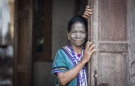 Chin region, Myanmar, November 11, 2014: daai tribe woman at her front doorのeditorial素材