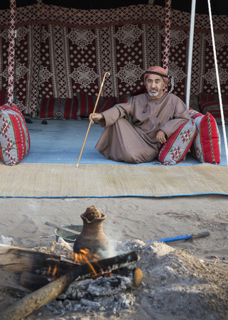 Muscat, Oman, February 4th, 2017: omani man with a walking stick restingのeditorial素材