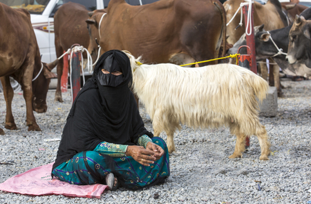 Nizwa, Oma, 24th March, 2017: omani woman at a goat marketのeditorial素材