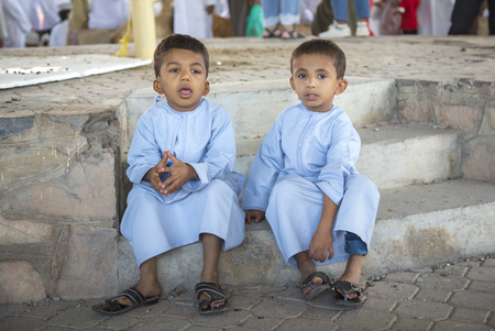 Nizwa, Oman, 24th March, 2017: brothers in traditional clothing in a market in Nizwaのeditorial素材