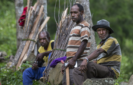 Baliem Valley, West Papua, Indonesia, February 12th, 2016: Locals resting on the side of a roadのeditorial素材