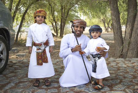 Nizwa, Oman - June 26th 2017: omani family dressed for Eid al Fitr day, that is celebrated at the end of Holy month of Ramadanのeditorial素材