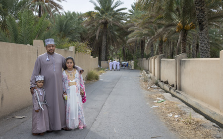 Nizwa, Oman - June 26th 2017: omani family dressed for Eid al Fitr day, that is celebrated at the end of Holy month of Ramadanのeditorial素材