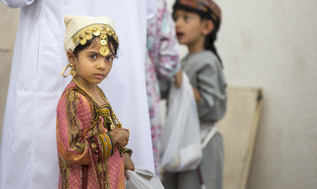Nizwa, Oman - June 26th 2017: little girl choosing a toy market on a day of Eid al Fitrのeditorial素材