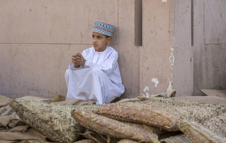 Nizwa, Oman, June 23rd, 2017: omani boy in traditional clothing at a marketのeditorial素材