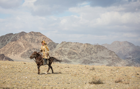 BAYAN ULGII, MONGOLIA - CIRCA OCTOBER 2015: kazakh man on his horseのeditorial素材
