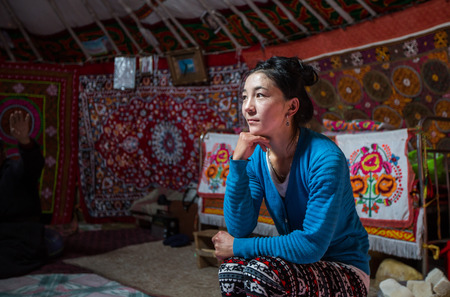 ULGII, MONGOLIA - CIRCA OCTOBER 2015: young woman in the kitchen part her home yurt