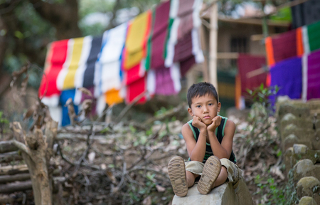 Chittagong, Bangladesh, February 25th, 2016: young Bangladeshi boy resting gin a countrysideのeditorial素材
