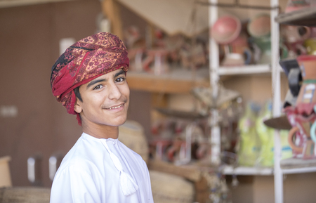 Nizwa, Oman, November 10th, 2017: omani boy dressed in traditional cloting, singingのeditorial素材