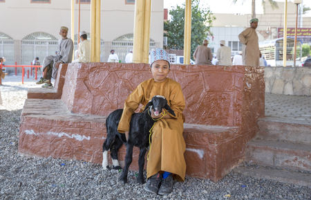 Nizwa, Oman, November 10th, 2017: omani boy with a goat at a marketのeditorial素材