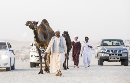 Madinat Zayed, United Arab Emirates, December 15th, 2017: arab man with his camel at The Million Street where camels get bought and soldのeditorial素材