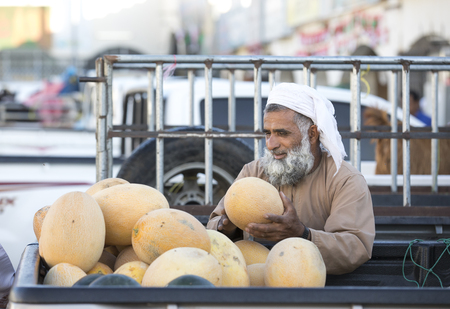 Sinaw, Oman, November 30th, 2017: bedhouin man at a market, selling melonsのeditorial素材