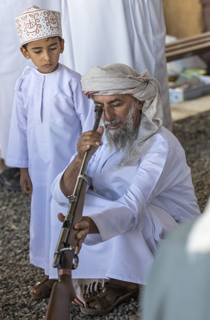 Sinaw, Oman, November 30th, 2017: man with a rifle at a gun marketのeditorial素材