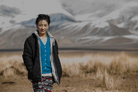 ULGII, MONGOLIA - CIRCA OCTOBER 2015: older Mongolian lady outside in a landscape of Western Mongoliaのeditorial素材