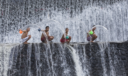 Bali, Indonesia, September 11th, 2016: Young Indonesian boys having fun at a waterfallのeditorial素材