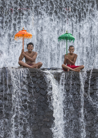 Bali, Indonesia, September 11th, 2016: Young Indonesian boys having fun at a waterfallのeditorial素材