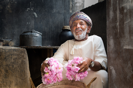 JABAL AL AKHDAR, OMAN - CIRCA APRIL 2016: three Omani man holding rose petals, to make rose waterのeditorial素材