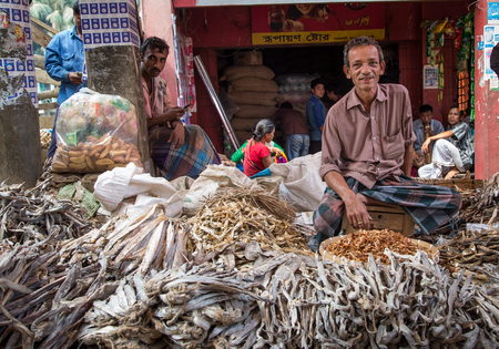 Chittagong, Bangladesh, 7th March, 2016: man is selling dry fish at a marketのeditorial素材