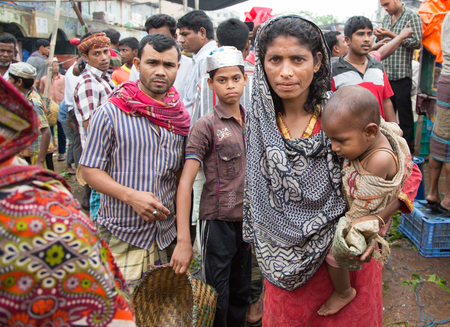 Chittagong, Bangladesh, 7th March, 2016: mother with her baby at a marketのeditorial素材