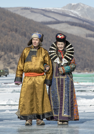 Hatgal, Mongolia, 4th March 2018: mongolian people dressed in traditional clothing on a frozen lake Khuvsgulのeditorial素材