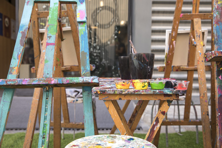 artist's paints and brushes on a tableの写真素材