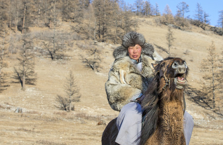 Hatgal, Mongolia, 4th March 2018: mongolian people dressed in traditional clothing on a frozen lake Khuvsgulのeditorial素材