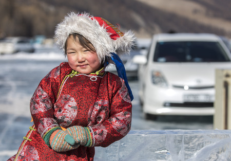 Hatgal, Mongolia, 4th March 2018: mongolian girl dressed in traditional clothing on a frozen lake Khuvsgulのeditorial素材