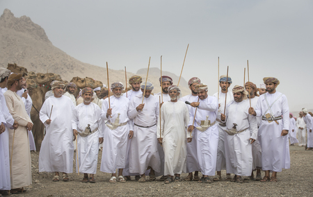 Khadal, Oman, 7th April, 2018: omani men singing and dancing after a camel race