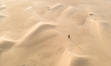woman in a traditional emirati dress called abaya in a desert near Dubaiの写真素材