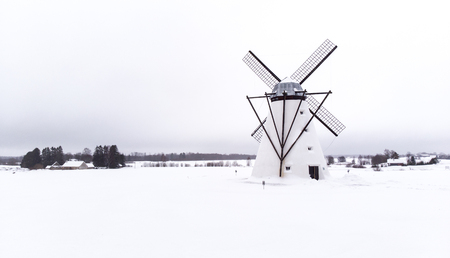 old windmill in estonian winter landscapeの写真素材