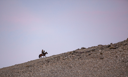 bayan Ulgii, Mongolia, 30th September 2015: kazak eagle hunter with his eagle in the mountainsの写真素材