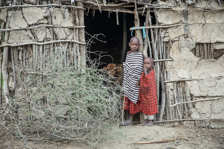 Same, Tanzania, 4th June, 2019:  Maasai kids at the door of their home in their boma (village)のeditorial素材