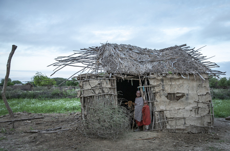 Same, Tanzania, 4th June, 2019:  Maasai kids at the door of their home in their boma (village)のeditorial素材